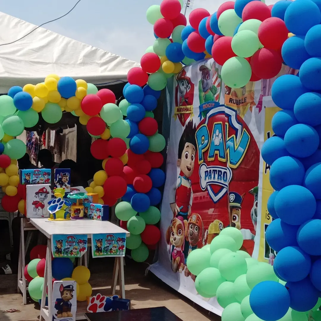 Paw Patrol backdrop and favour table surrounded by colourful balloon arches